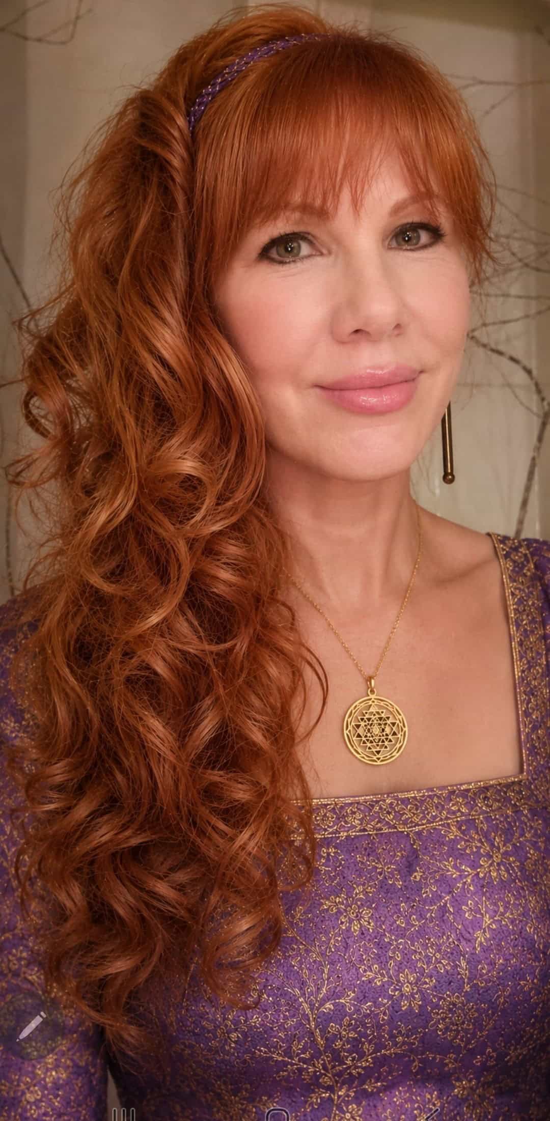 Portrait of Rev Claire Luft with red hair and purple dress.